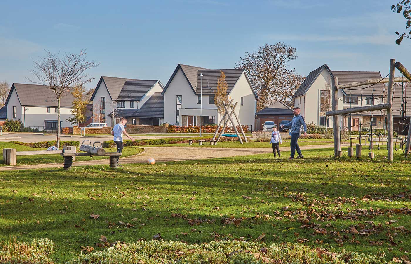 A family playing football at a Crest Nicholson development