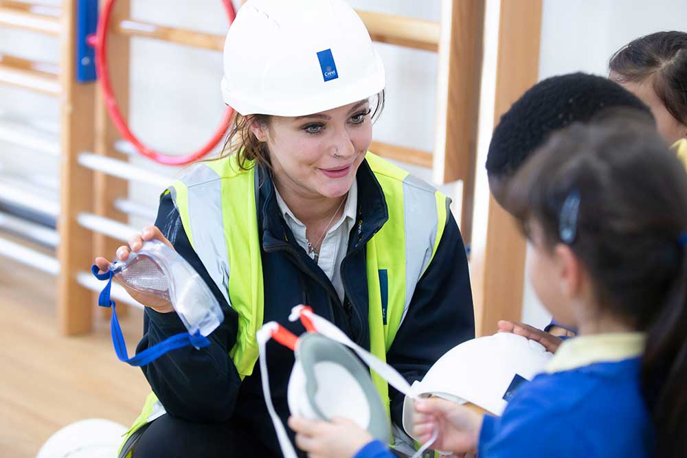 Crest Nicholson employee teaching pupils about safety