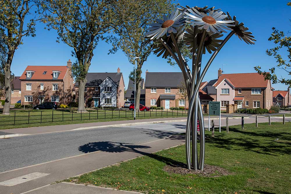 Crest nicholson development street scene image with steel flower