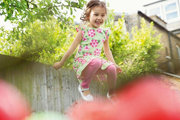 A young girl playing in a Crest Nicholson garden