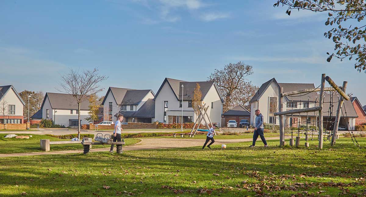 A family playing football at a Crest Nicholson development